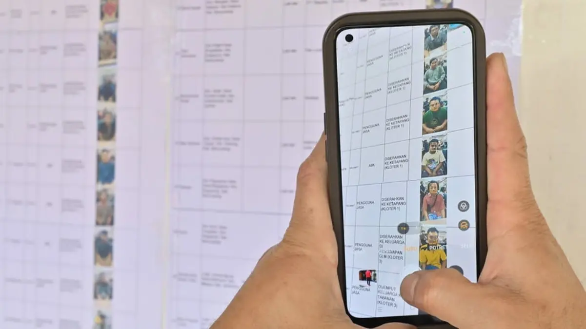Warga memotret data korban selamat dalam peristiwa tenggelamnya KMP Tunu Pratama Jaya di Pelabuhan Gilimanuk,