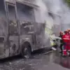 Para Petugas Pemadam Kebakaran (Damkar) bekerja keras memadamkan kobaran api yang melumat mobil bus di KM 95+1