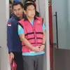 Ketua Ombudsman RI, Hery Susanto berjalan menuju mobil tahanan di gedung Kejaksaan Agung, Jakarta, Kamis (16/4