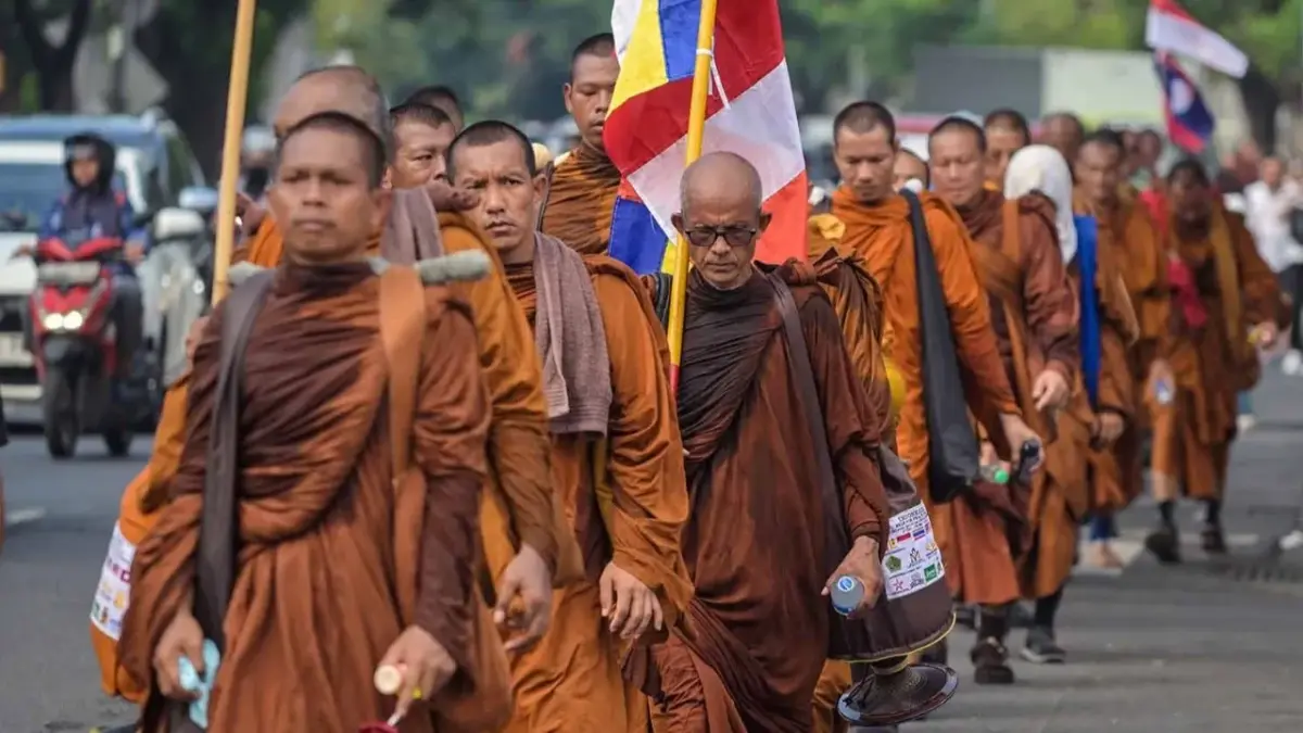 Sekelompok biksu Buddha berjalan kaki mengikuti Pawai Perdamaian 2026 di Surabaya, Jumat (15/05/2026). (AFP/ J