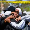 Anggota komunitas muslim berpelukan dari tempat insiden penembakan di San Diego, California, AS, 18 Mei 2026.