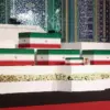 Pemuka agama Iran bersama para pelayat memberikan penghormatan di hadapan peti jenazah Ali Khamenei serta angg