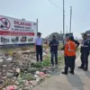 Petugas kereta api dari Daop 3 Cirebon memasang imbauan untuk tidak membakar dan membiang sampah di sepanjang