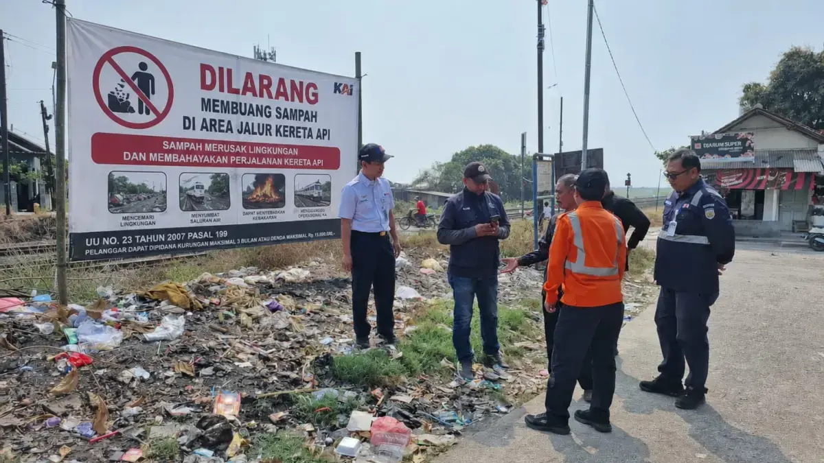 Petugas kereta api dari Daop 3 Cirebon memasang imbauan untuk tidak membakar dan membiang sampah di sepanjang